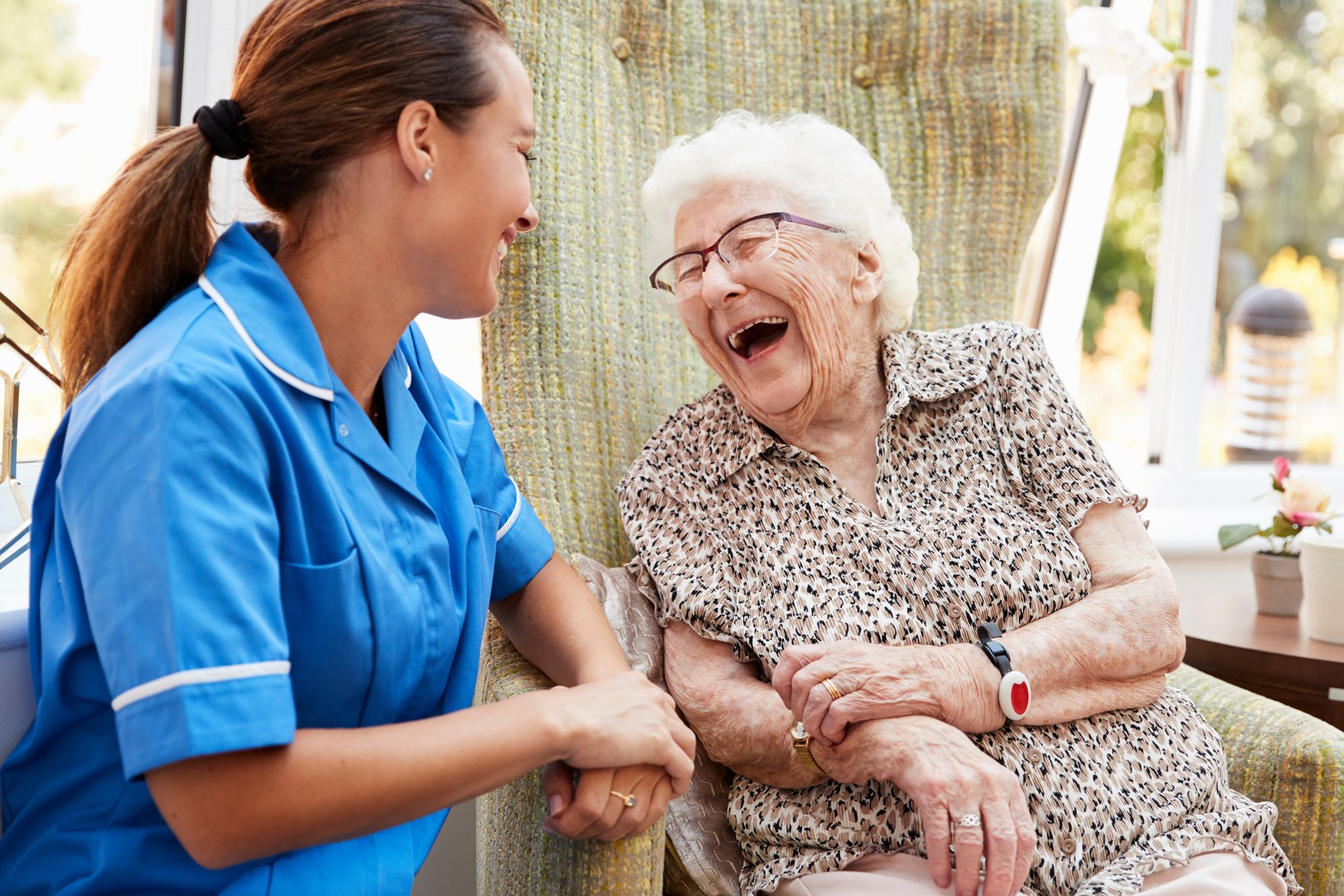 A caregiver sharing a happy moment with an older adult